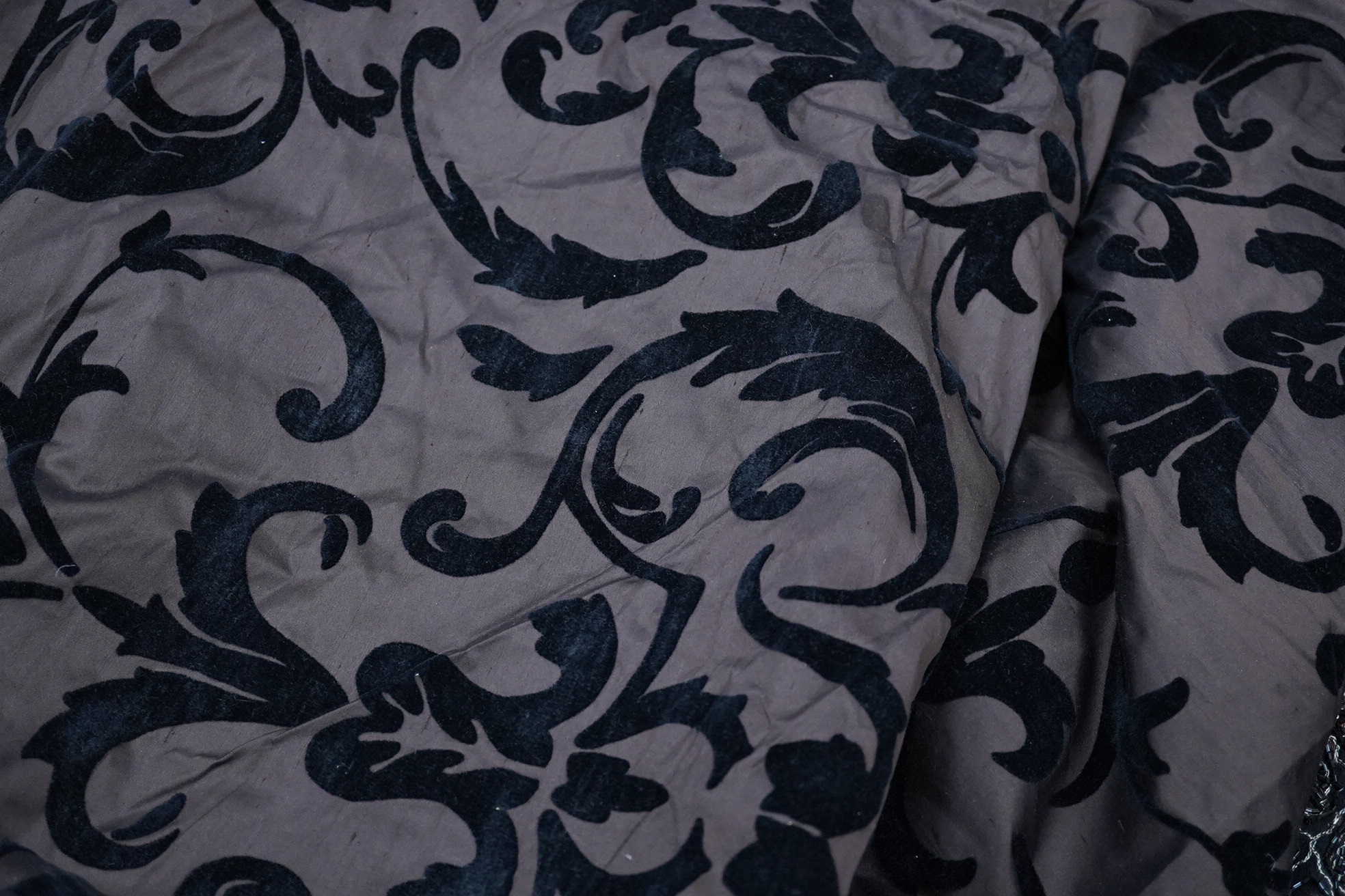 A length of silk velvet flocked taffeta, a purple silk panel, a mid century beaded length and two lengths of late 20th century braiding